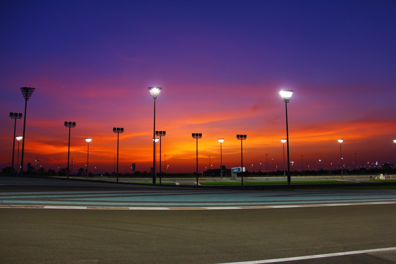 Yas Marina Circuit at dusk, with the marina and the hotel over the track